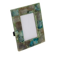 a green and brown photo frame sitting on top of a table