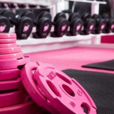 pink plates stacked on top of each other in a gym