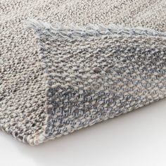 a close up view of a gray and white rug