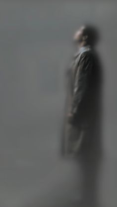 a blurry image of a man standing in the fog