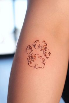 a woman's arm with a small tattoo design on the back of her leg