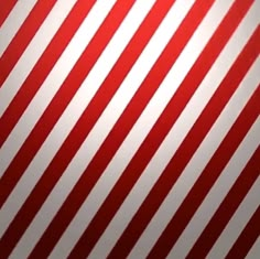 red and white striped wallpaper that is very diagonal to the camera man's eye