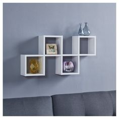 three white cube shelves on the wall above a couch