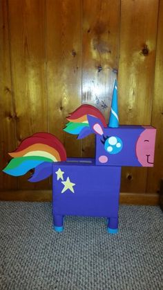 a cardboard unicorn sitting on top of a rug