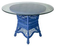 a blue wicker table with glass top