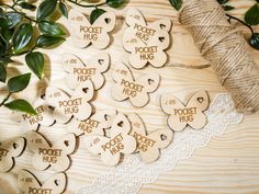 wooden tags with the words pocket hug written on them next to a spool of twine