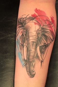 an elephant tattoo on the leg of a woman's leg with red and blue ink