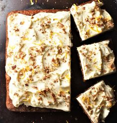 there are four pieces of bread with white frosting on it and one slice has been cut