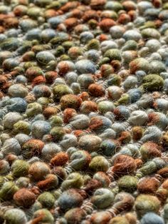 a close up view of an area rug with many different colored balls on it