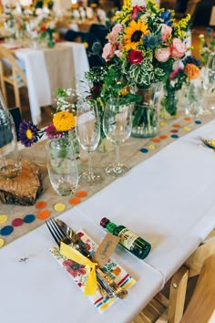 the table is set with wine glasses and confetti for guests to sit at