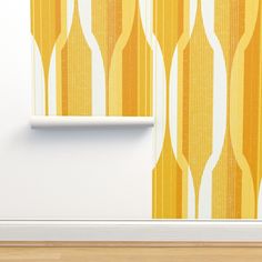 an orange and yellow wallpaper with white lines on it in front of a wooden floor