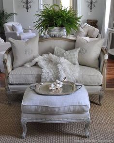 a living room filled with furniture and pillows