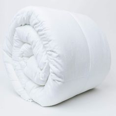 an unmade white comforter on a white background