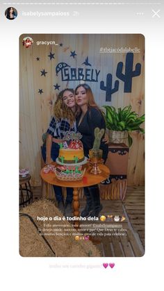 two women standing next to each other in front of a cake