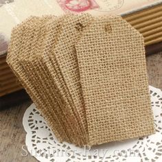 small burlap bags are sitting on a doily