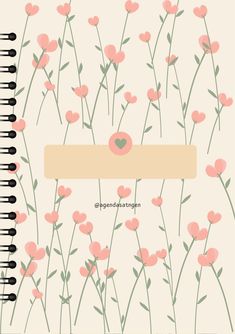 a spiral notebook with pink flowers and a heart on the front, surrounded by black pins