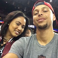 a man standing next to a woman at a basketball game