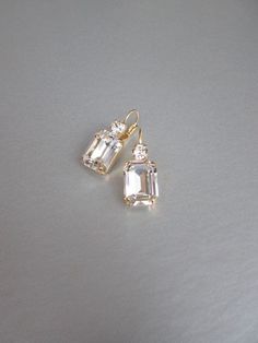 "These beautiful elegant earrings are made with fancy emerald cut and round Swarovski crystals. Available in gold, rose gold and silver finish. Matching necklaces an the bracelet are also available and they are shown in the last two photos. - 1 3/8\" long from the top of the ear wire to the bottom of the earring and 1/2\" wide - Leverback - For the matching bracelet please take a look here: https://www.etsy.com/listing/754440549/swarovski-crystal-bridal-bracelet-gold?ref=shop_home_active_19& Bridal Gold Earrings, Wedding Drop Earrings, Inexpensive Jewelry, Earrings Emerald, Gold Bridal Earrings, Wedding Earrings Drop, Matching Jewelry, Jewelry Lookbook, Earrings In Gold