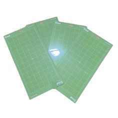 three pieces of green cutting board on a white background