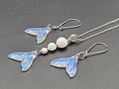 two necklaces with butterfly wings and pearls