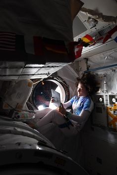 a woman is sitting in the space station