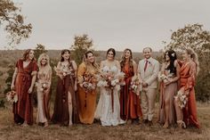 a group of people standing next to each other on top of a grass covered field