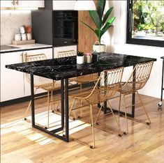 a black marble table and chairs in a kitchen