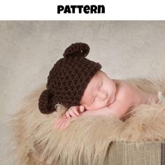 a newborn baby wearing a brown knitted bear hat