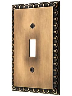 an antique style light switch plate with decorative designs on the front and back plates in bronze