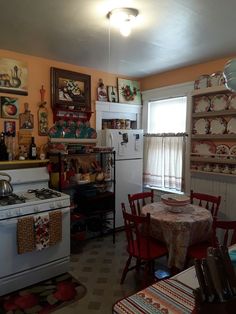 a kitchen with an oven, stove and table covered in dishes on the counter top