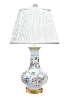 a lamp that is on top of a table with a white lampshade over it