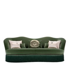 a green couch with pillows on top of it