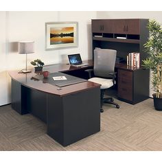 an office cubicle with desk, chair and computer