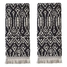 two black and white rugs with fringe ends