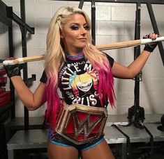 a woman with pink hair is holding a baseball bat and wearing a wrestling outfit while posing for the camera