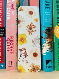 books are lined up next to each other in front of a row of colorful books