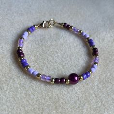 - One Of A Kind Beaded Bracelet - Featuring Light Purple, Dark Purple, And Gold Seed Beads With A White Pearl Bead At The Center - Gold Colored Hardware - Clasps Closed. No Stretch. - Size/ Circumference Is 7” - Handmade (By Myself). Perfect To Treat Yourself Or To Give As A Unique Gift! **Add 2 Jewelry Items Marked “2 For $20” To Your Bundle And I Will Send You An Offer For $20** Tags: Beaded, Handmade Jewelry, Colorblock, Ocean, Pearls Check Out The “Boutique” Tab In My Closet For Handmade Ear Purple Jewelry Bracelet, Purple Beaded Bracelets, Heart Bangle Bracelet, Gold Beaded Bracelet, Gray Bracelet, Black Beaded Bracelets, Purple Dark, Purple Bracelet, Beaded Cuff Bracelet