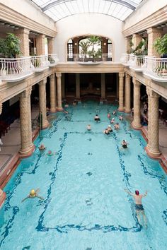 an indoor swimming pool with people in it