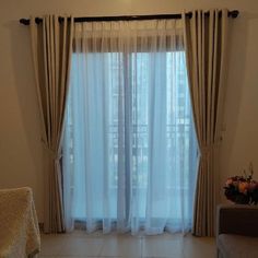 a living room filled with furniture and curtains