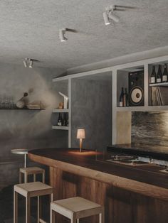 an empty bar with stools in front of it