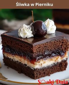 there is a piece of cake with chocolate and whipped cream on top, along with two cherries