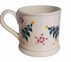 a white coffee cup with christmas decorations on the outside and inside, sitting in front of a white background