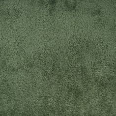 an area rug that looks like it has been made with green carpeting and is very soft