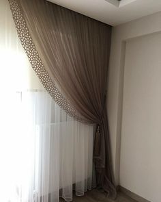 a window with sheer curtains in front of it and a wooden floor next to the window