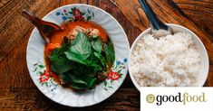 a plate with rice, meat and greens on it next to a bowl of white rice