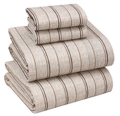 four folded sheets are stacked on top of each other in beige and brown striped linens