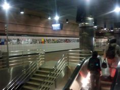 an escalator in a subway station with people on it