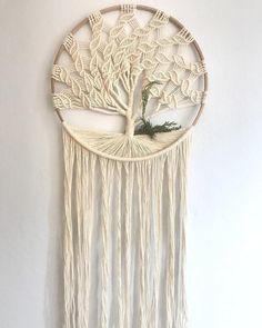 a white wall hanging with a tree on it