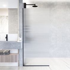 a bathroom with a sink, mirror and shower stall in the middle of the room