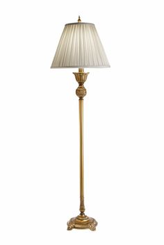 a gold lamp with a white shade on it